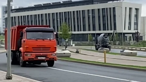 Building under construction working crane driving big trucks concrete mixer Stock Footage 159709447