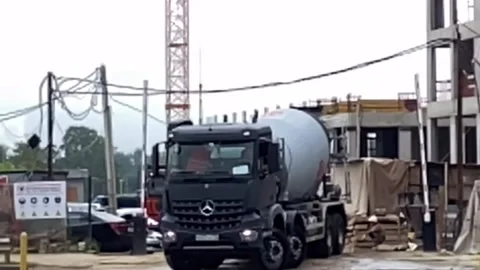 Building under construction working crane driving big trucks concrete mixer Stock Footage 159709482