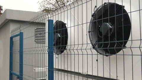 Building ventilation system HVAC behind the fence Stockbeeldmateriaal 106028264