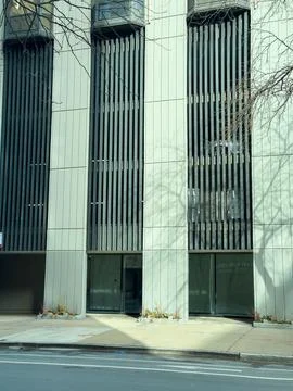 Building with vertical slats and empty windows on the street during dayligh.. Stock Photos