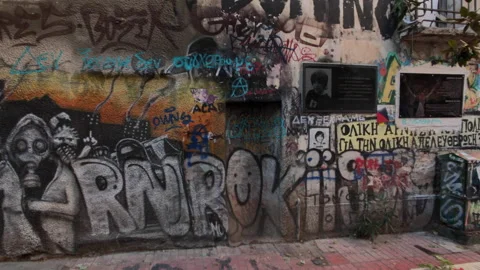 Building wall covered with murals and grafitti Stock Footage 146649542