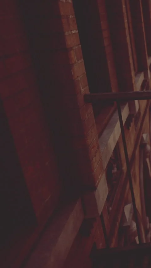 Building wall with red brick and railing at dusk in a city location Stock Footage 339106961