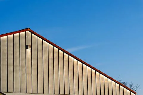 Building wall with vertical stripes under blue sky Stock Photos