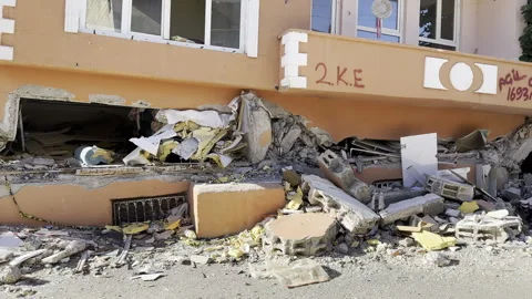A building whose ground floor collapsed in an earthquake. Earthquake disaster. Stock Footage 246453588
