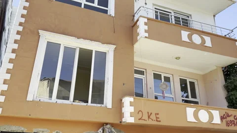 A building whose ground floor collapsed in an earthquake. Earthquake disaster. Stock Footage 246454956