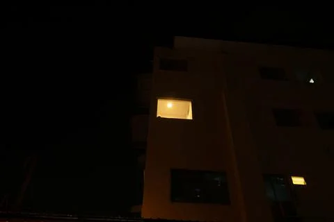 A building with a window that is lit up Stock Photos