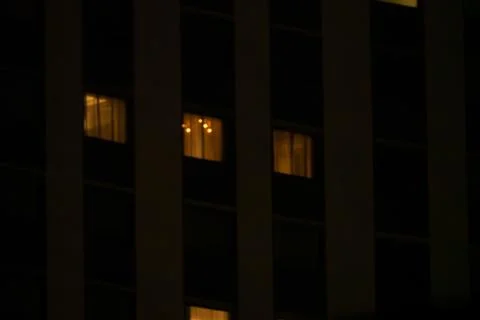 A building with windows lit up at night Foto stock