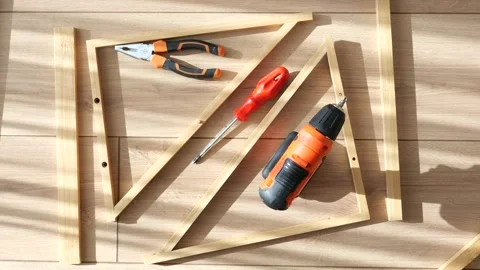 Building a wooden frame using tools in a well-lit workspace Vídeos de archivo 311145603