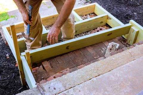 Building wooden steps frame on bricks in backyard Stock Photos