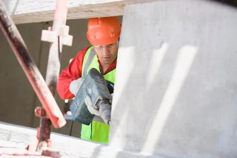 Building worker handling a drill Fotos de archivo