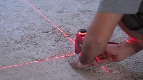 Building worker setting modern laser level on the floor on construction site for Stock-Footage 133772760