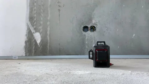 Building worker setting modern laser level on the floor on construction site 스톡 동영상 153810144