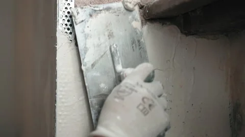 Building worker using metal spatula and spackling paste solution for putty walls Stock-Footage 148993422