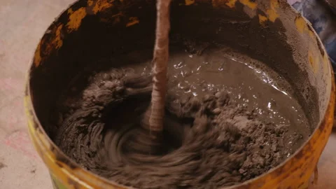 Building.Plastic Bucket. Cement. Glue. Solution. Rotating Nozzle Mixes Substance Stock Footage 146107199