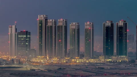 Buildings on Al Reem island in Abu Dhabi night to day timelapse from above. Stock Footage 155333053