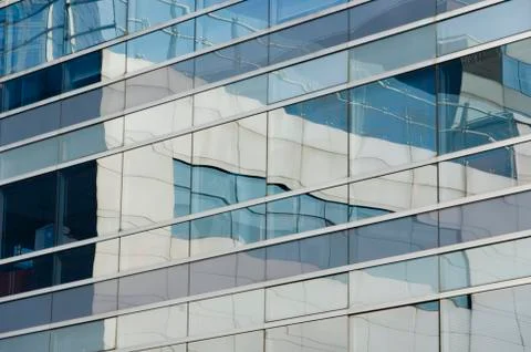 Buildings that are reflected in another generating an image of lines and colo Stock Photos