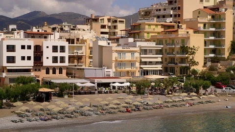 BUILDINGS EASTERN BAY BEACH AGIOS NIKOLAOS CRETE Stock Footage 70703647