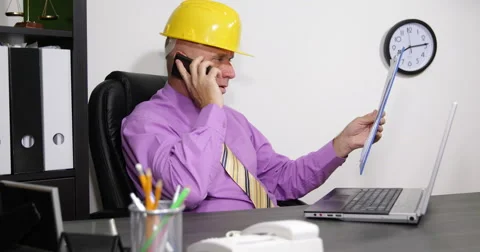 Buildings Engineer Cellphone Talk Read Clipboard Data Sheet Type in Laptop File 스톡 동영상 58557400
