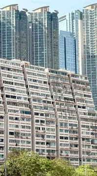 The building's facade features a distinctive pattern of windows and balconies Stock Photos
