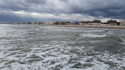 Buildings near the beach in storm with dramatic clouds on the sky. Rough Stock Footage 123427901