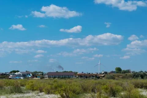 Buildings powered with green electricity generated by windmils Stock Photos