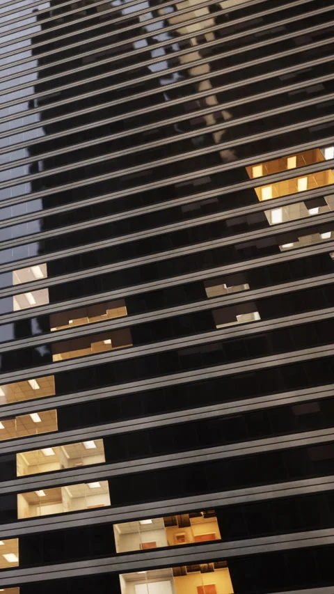 Buildings reflect light in city during evening hours with patterned windows Stock Footage 340630542