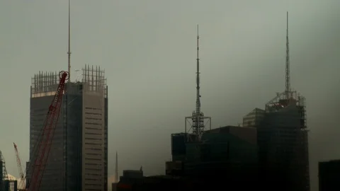 Buildings under construction on cloudy day with crane operating. 스톡 동영상 106149839
