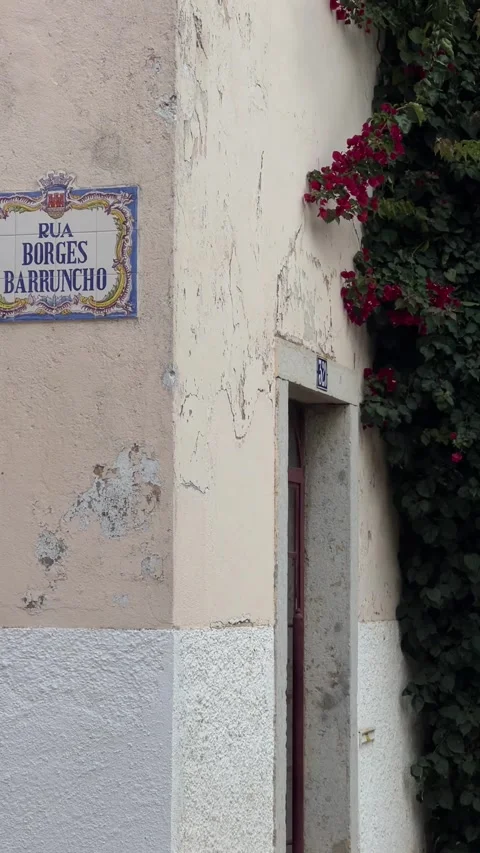 Building's wall with street name table in Cascais, Portugal. Vertical Stock Footage 241023789