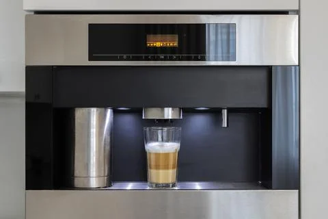 Built-in automatic coffee machine in kitchen furniture Stock Photos
