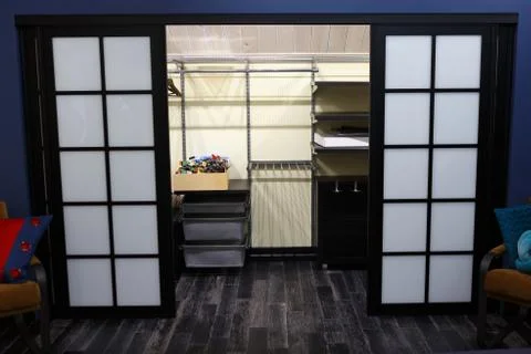 Built-in closet for things. Large square doors. 스톡 사진