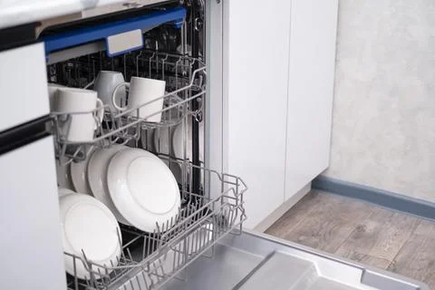 Built-in dishwasher door open. Kitchen with built-in appliances Stock Photos