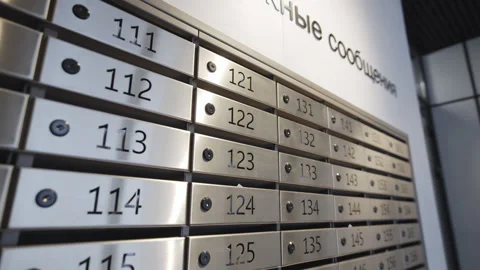 Built-in metallic mailboxes repeat along solid wall Stock Footage 330095088