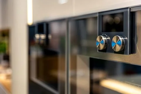 Built-in oven details with metallic knobs. Modern kitchen appliances in int.. Stock Photos
