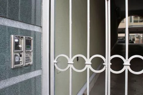 Built into the wall panel intercom with a gate and a prospect of the courtyar Stock Photos