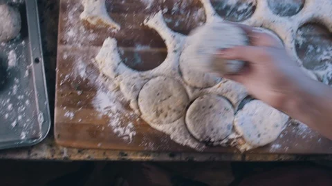 Buiscuits on metal pan with flour sprinkle before baking in kitchen Stock Footage 117948880