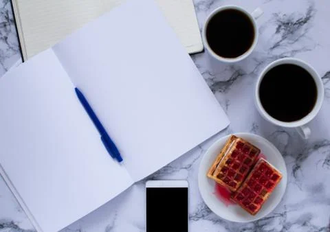 Buisness lunch with two coffe anf waffles and planning the day and smartphone Stock Photos
