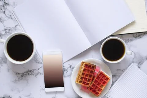 Buisness lunch with two coffe anf waffles and planning the day and smartphone Stock Photos