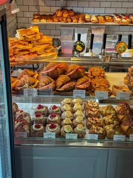 Buka bakery inner showcase with different danish pastry: buns, croissants a.. Stock Photos