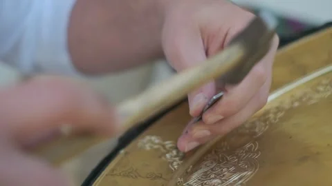 Bukhara master engraves patterns on a tray. Close up Stock Footage 142340743