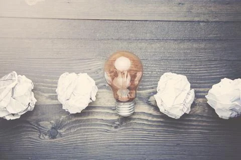 Bulb and papers Stock Photos
