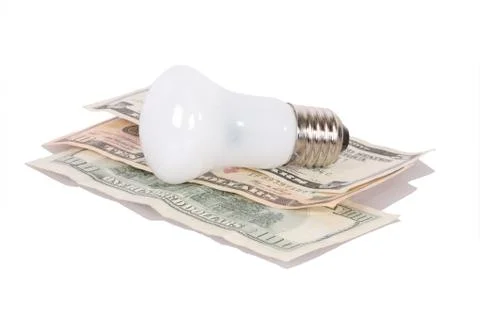 Bulb on dollars Stock Photos