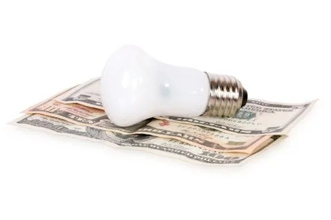 Bulb on dollars Stock Photos