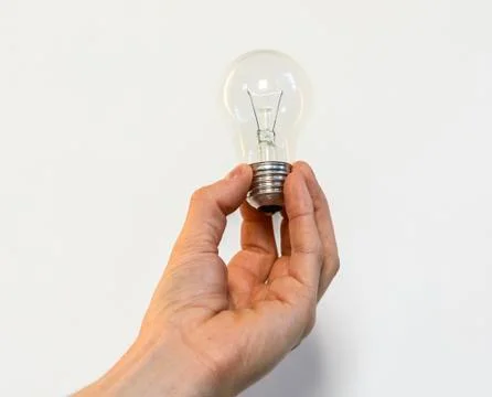 Bulb in a hand Stock Photos
