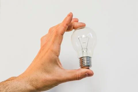 Bulb in a hand Stock Photos