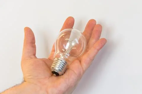 Bulb in a hand Stock Photos