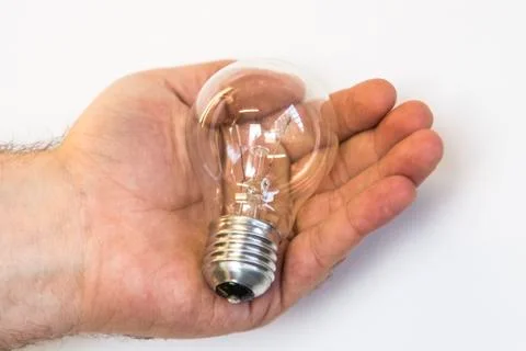 Bulb in a hand Stock Photos