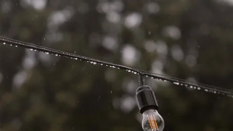A bulb lamp outside under a rain. Stock Footage 169892102
