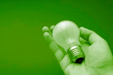 Bulb in a man hand Stock Photos