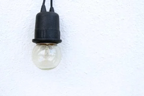 Bulb on white wall background Stock Photos