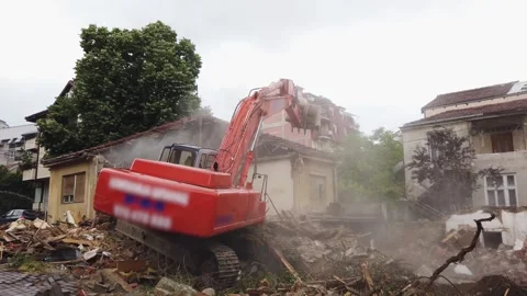 Buldozer operating at a construction site during demolition work in an urban Stock Footage 344319472